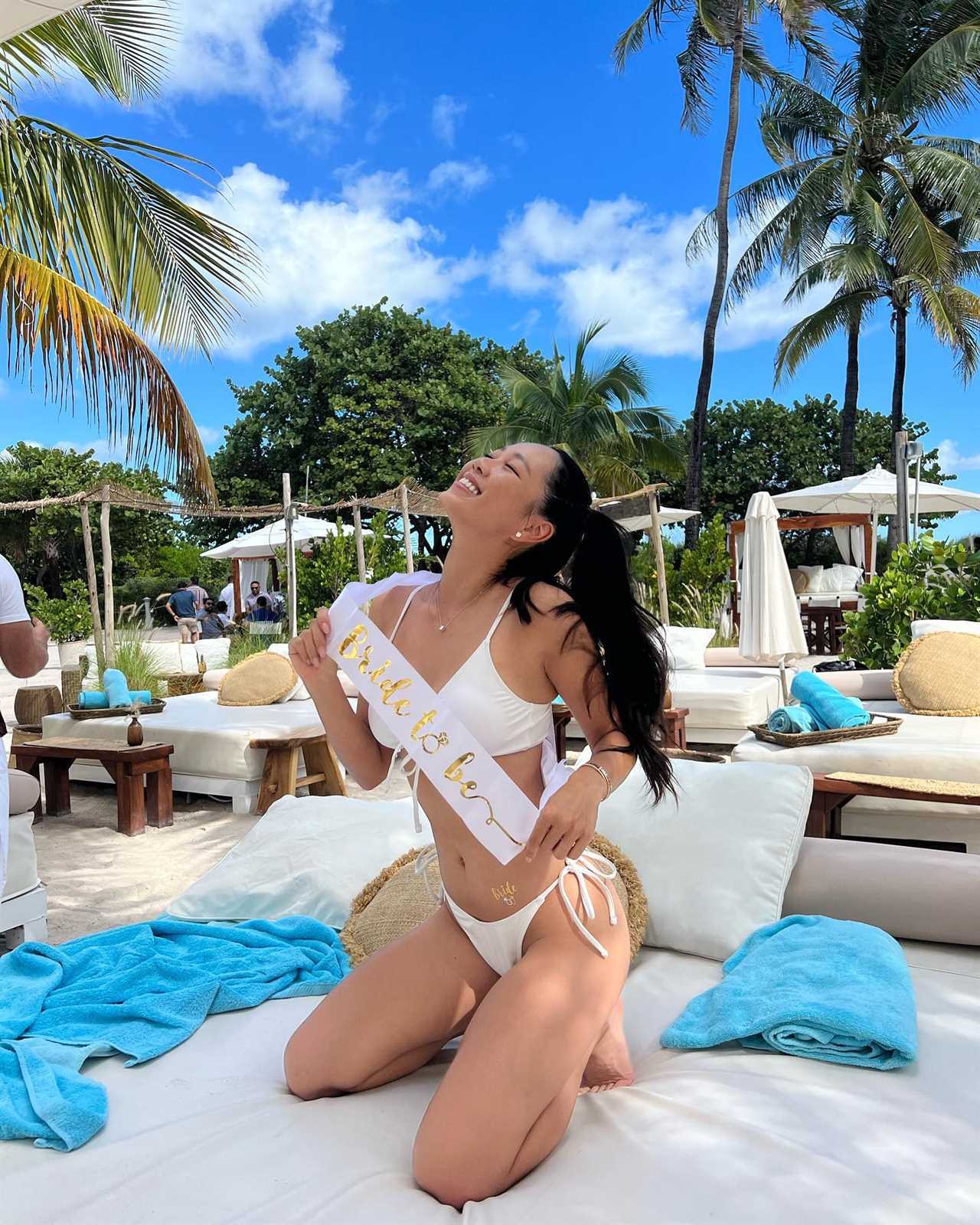 Bride-to-be in white bikini on beach lounge chair.