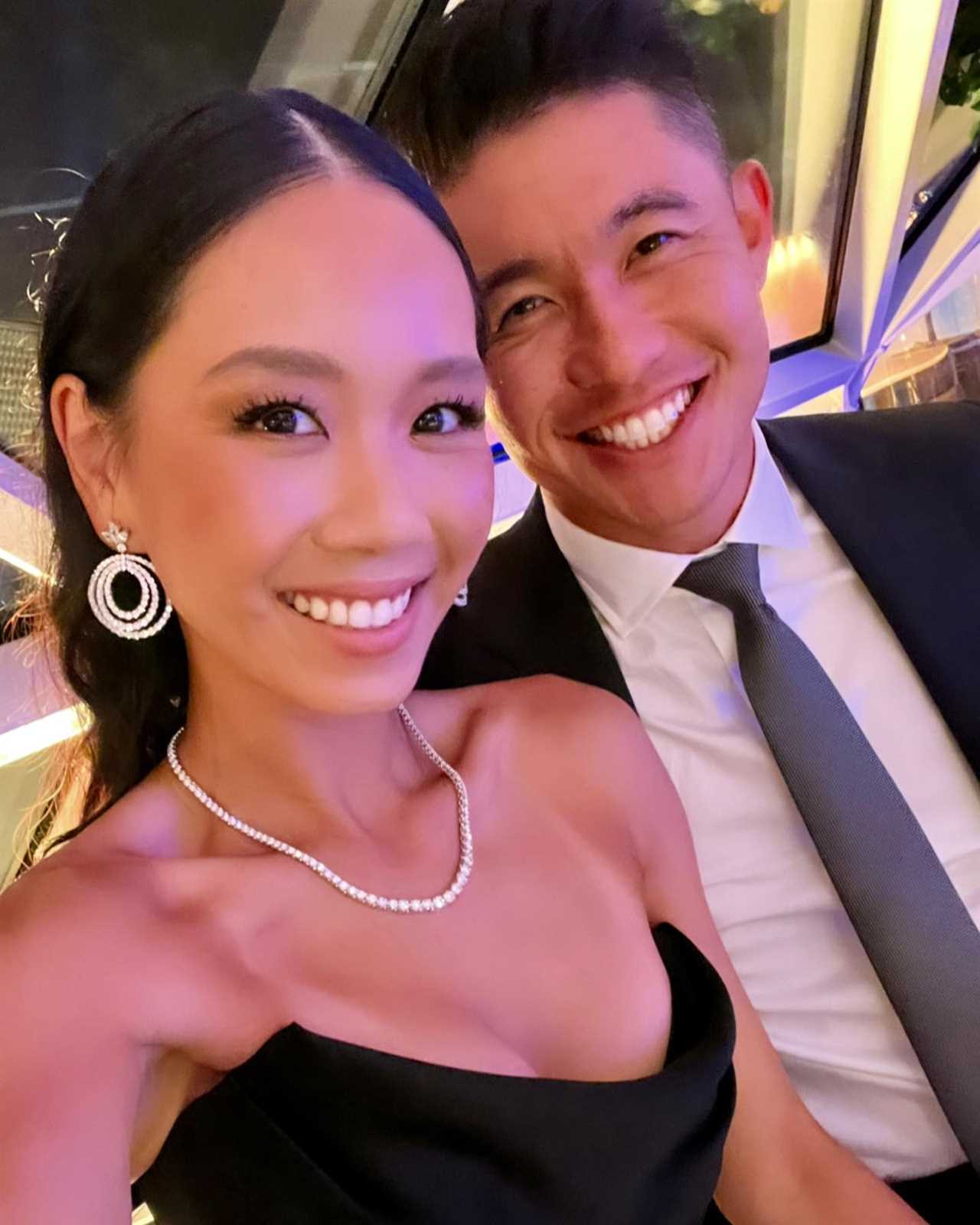Couple in formal wear smiling for a selfie.