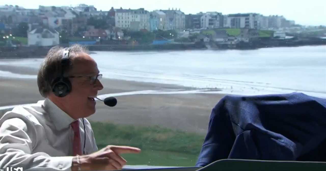 Sportscaster broadcasting with a coastal town in the background.