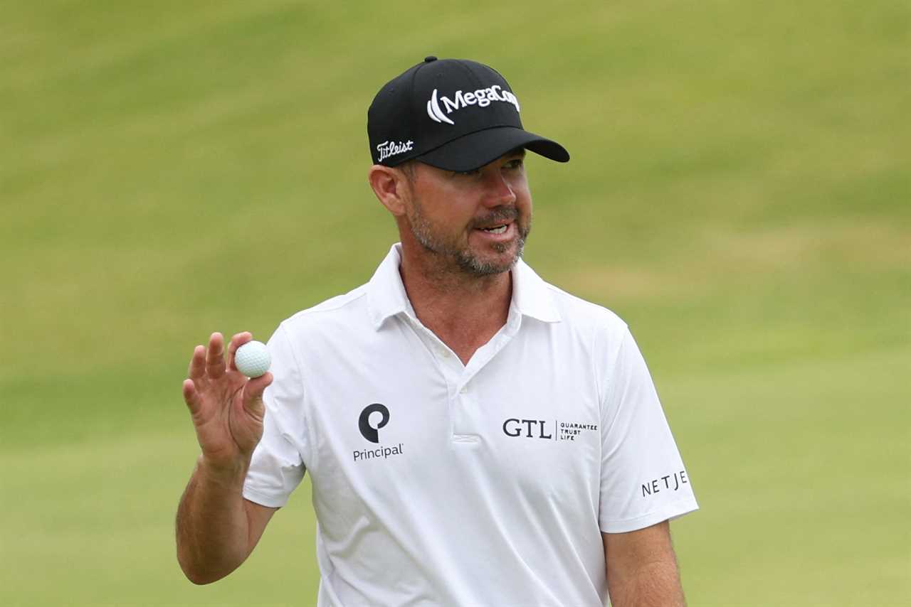 Brian Harman holding a golf ball.