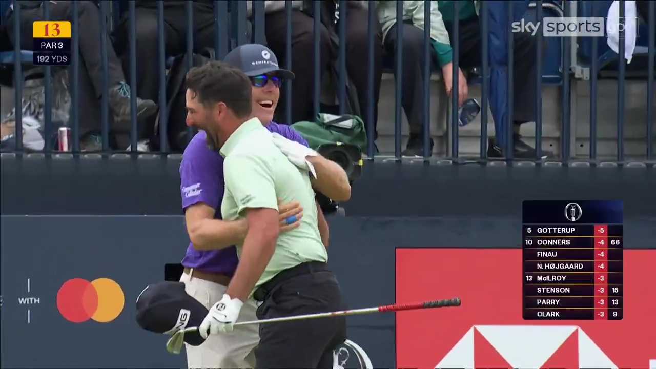 Two golfers hugging after a hole-in-one.