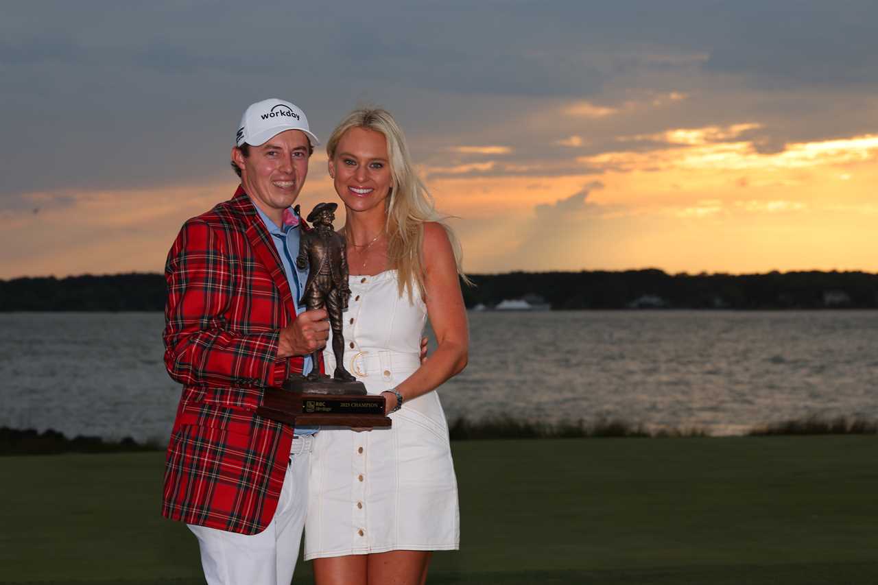 Matt Fitzpatrick and his girlfriend celebrating his golf tournament win with a trophy.