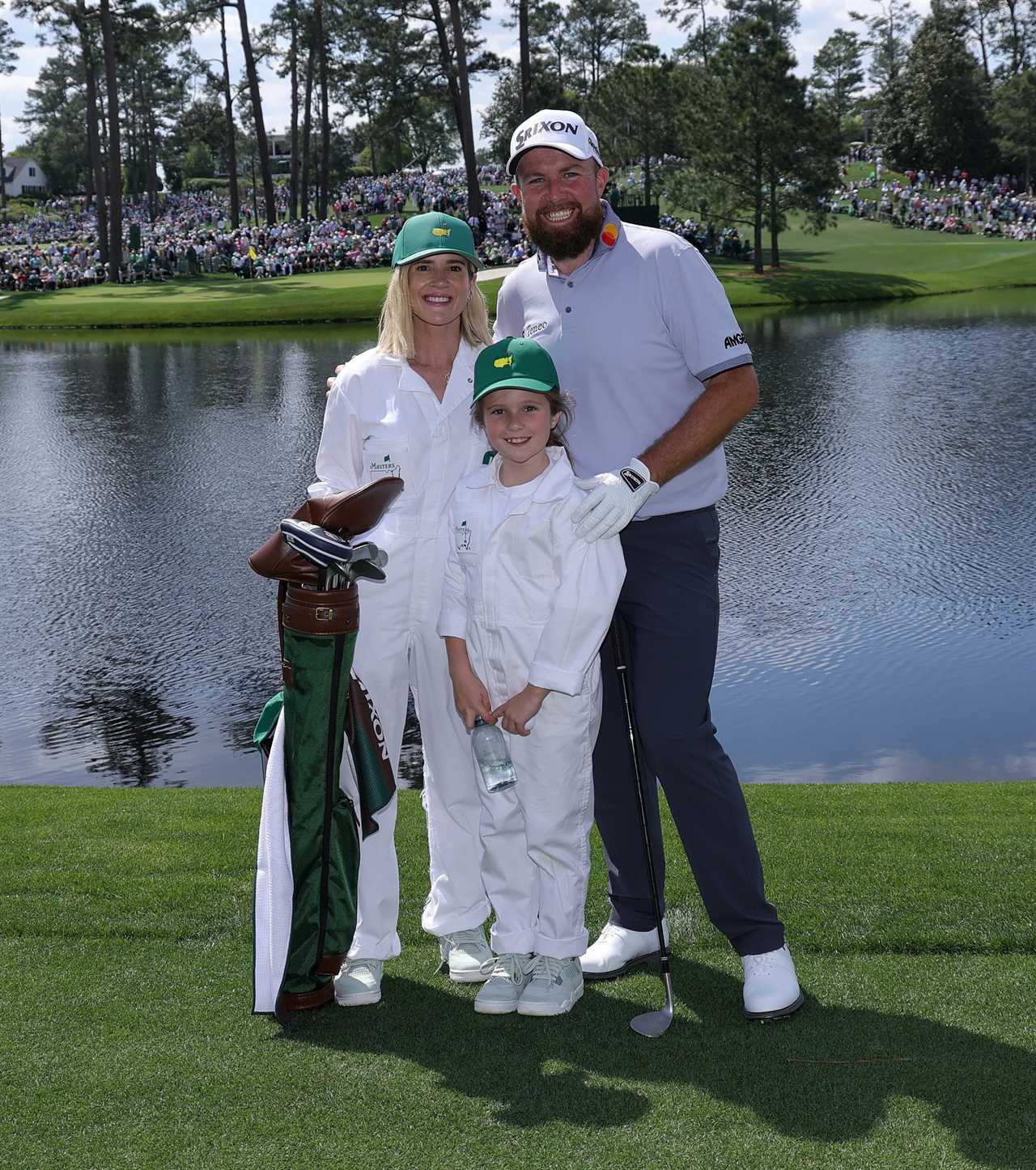 Shane Lowry with his wife and daughter at a golf course.