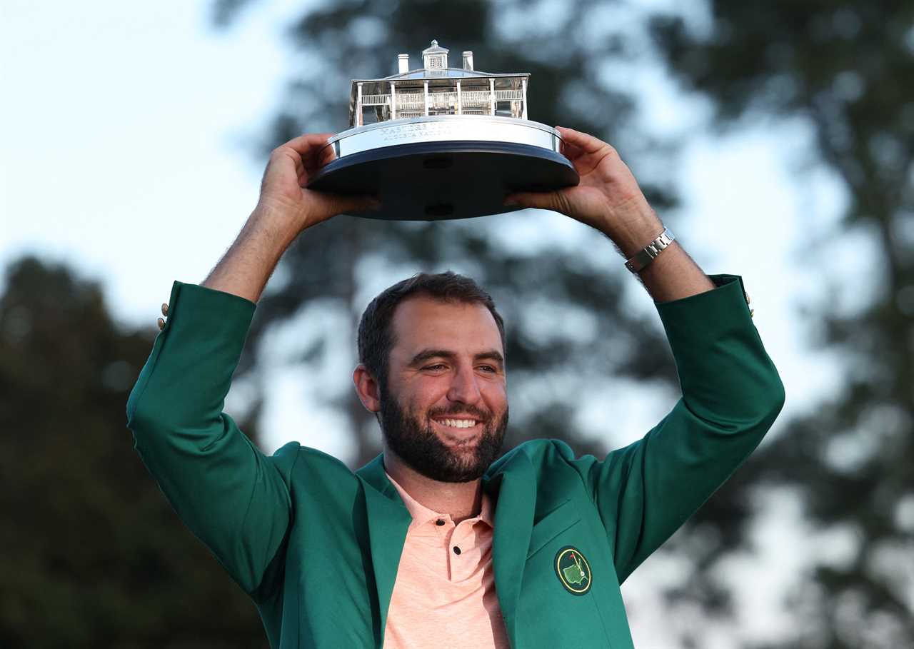 Scottie Scheffler holding the Masters Tournament trophy.