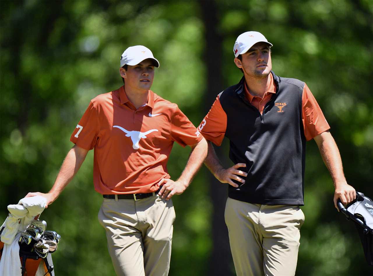 Two Texas Longhorns golfers on a golf course.