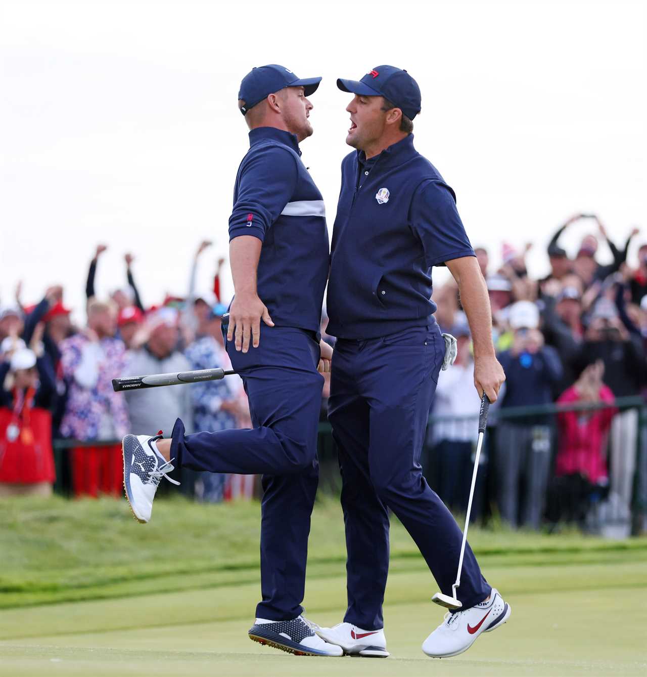 Bryson DeChambeau and Scottie Scheffler celebrating on the 15th green at the Ryder Cup.