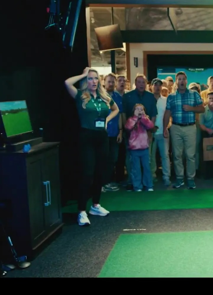 Adam Sandler and Paige Spiranac in a scene from the Happy Gilmore 2 trailer.