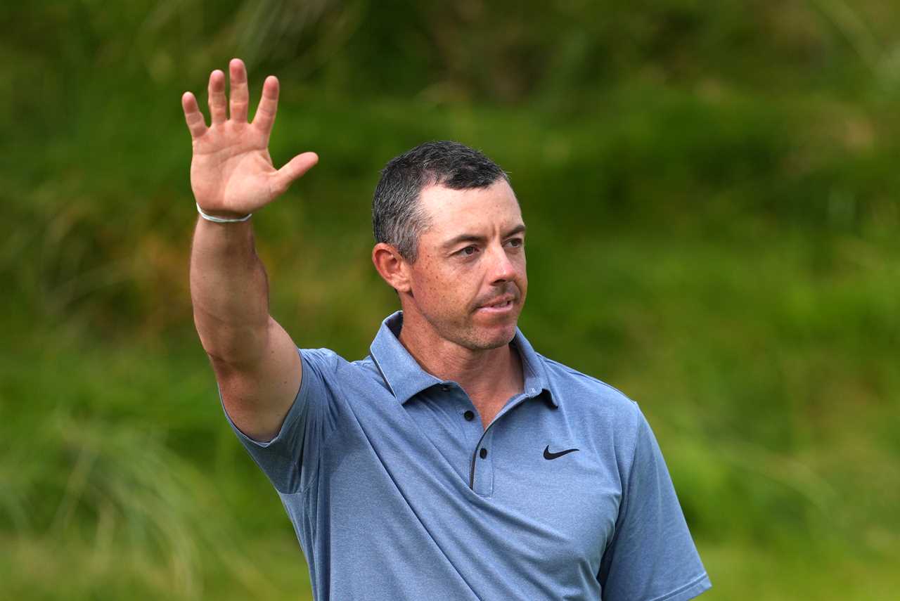 Rory McIlroy waves to spectators.