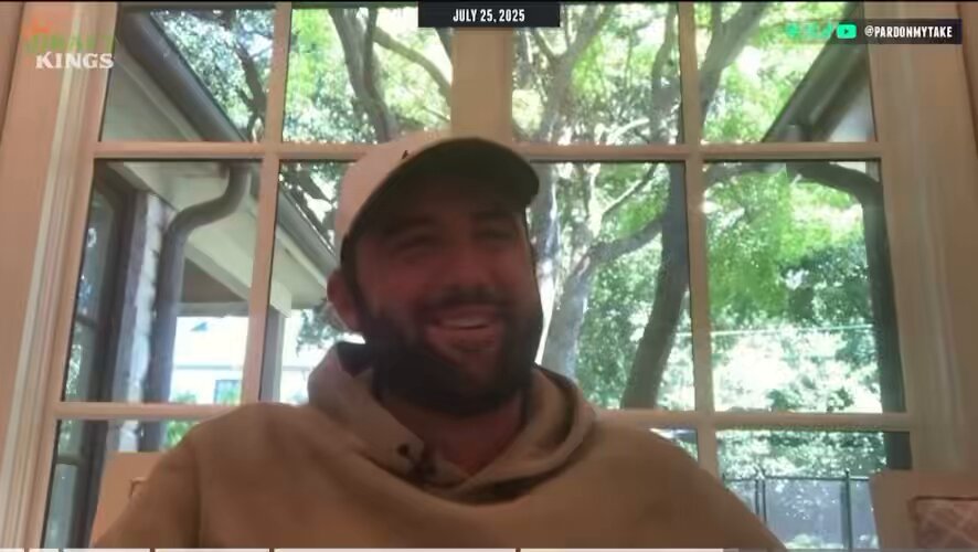 Man smiling in front of a window.