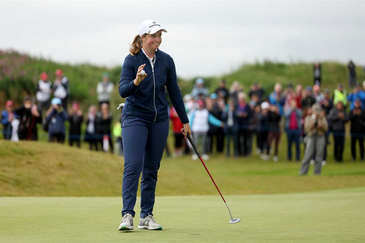 Lottie Woad of England acknowledges the crowd after winning a golf tournament.