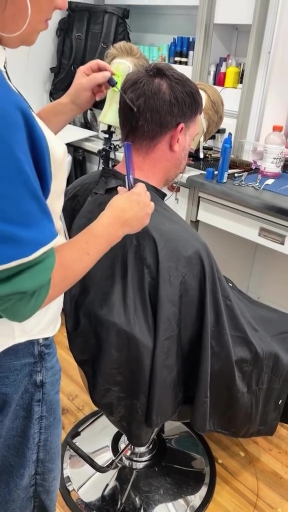 A man getting his hair styled for a movie.