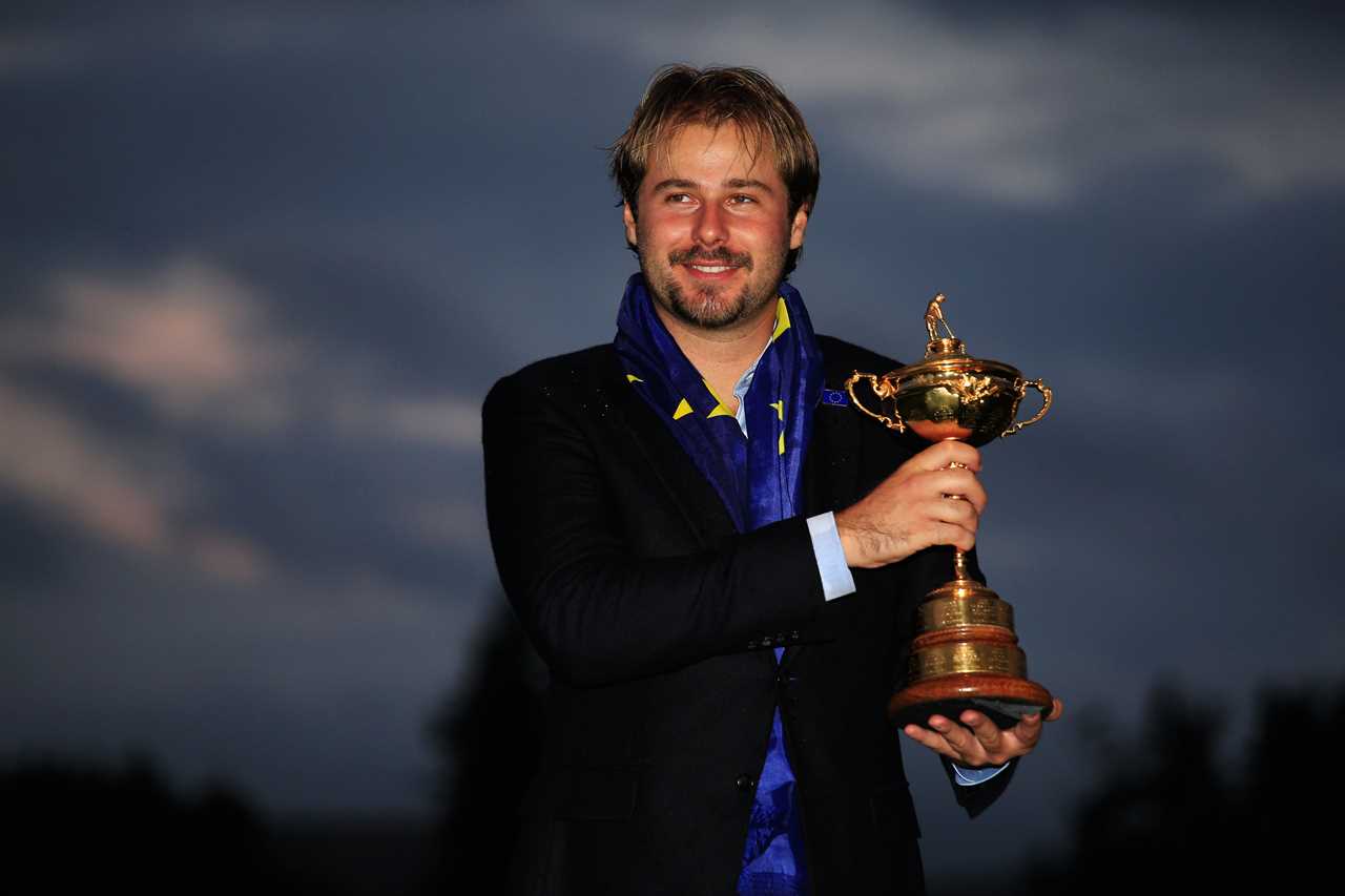 Victor Dubuisson holding the Ryder Cup trophy.