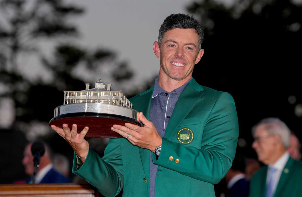 Rory McIlroy holding the Masters Championship trophy.