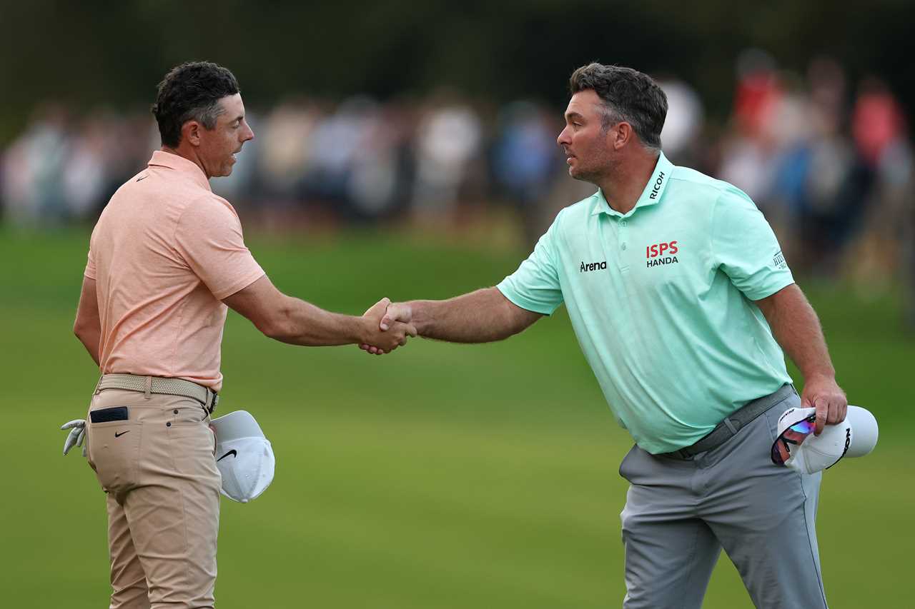 Rory McIlroy and Ryan Fox shaking hands on a golf course.