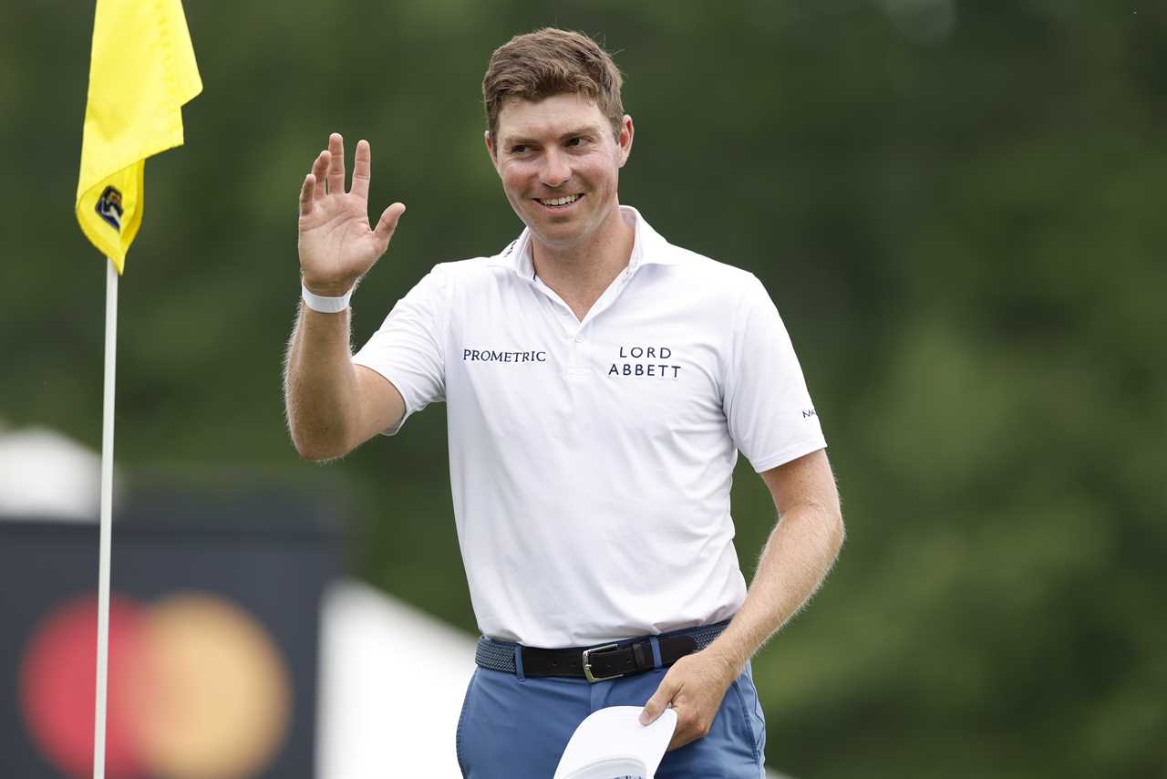 Ben Griffin of the United States acknowledges the crowd at a golf tournament.