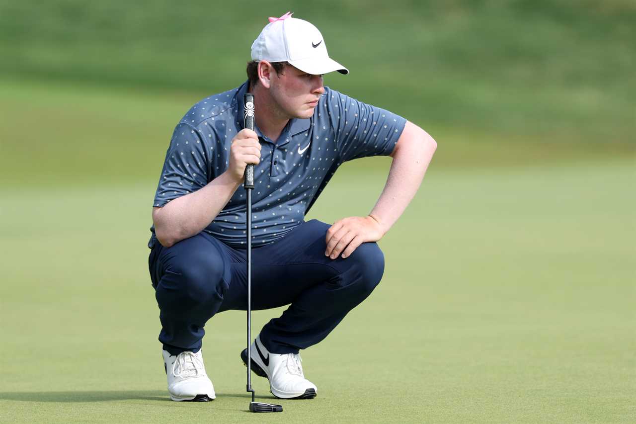 Robert MacIntyre of Scotland lining up a putt.