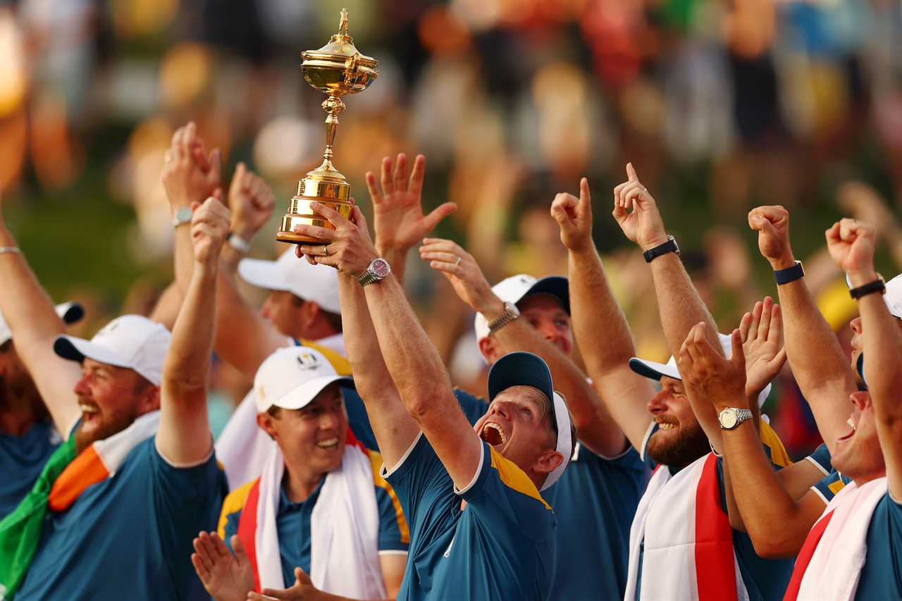 Team Europe captain Luke Donald lifting the Ryder Cup trophy with his team.