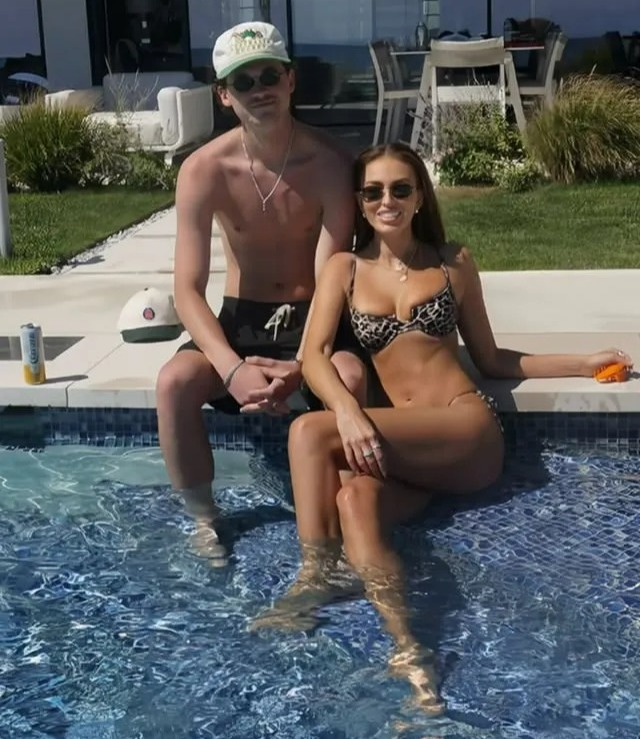 Paulina Gretzky by the pool with a young man.